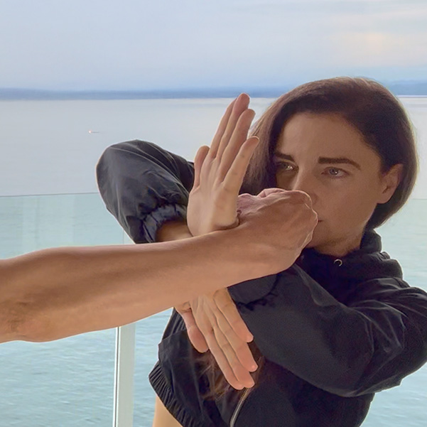 Kendra Mahon demonstrating Bong Sao, deflecting an incoming punch